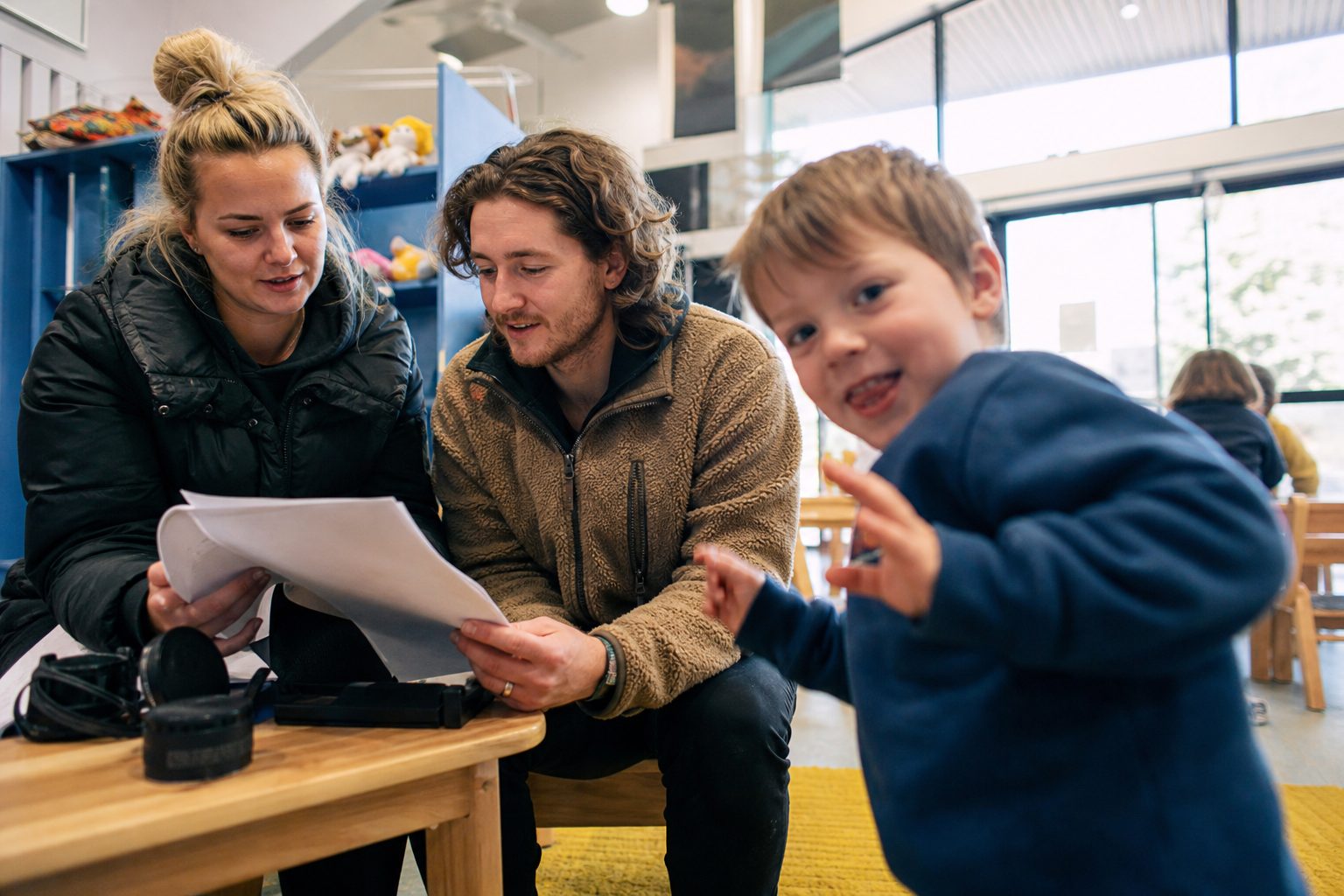 Educator and photographer reviewing a list together in a childcare room