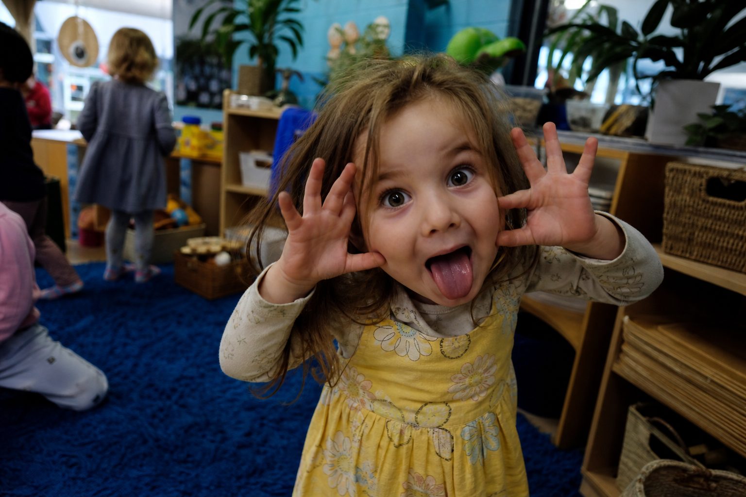 Child pulling a monster face with hands up