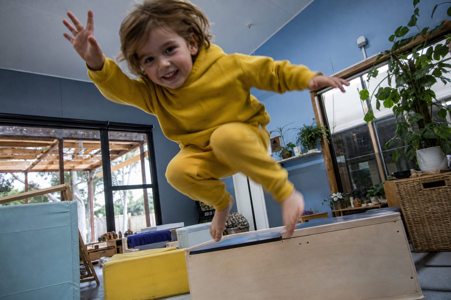 Child mid-jump with both feet off the ground