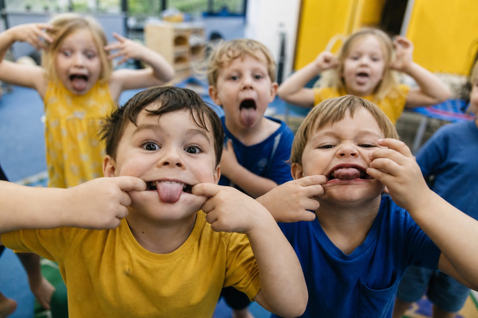 Chaotic room group of preschoolers all pulling faces