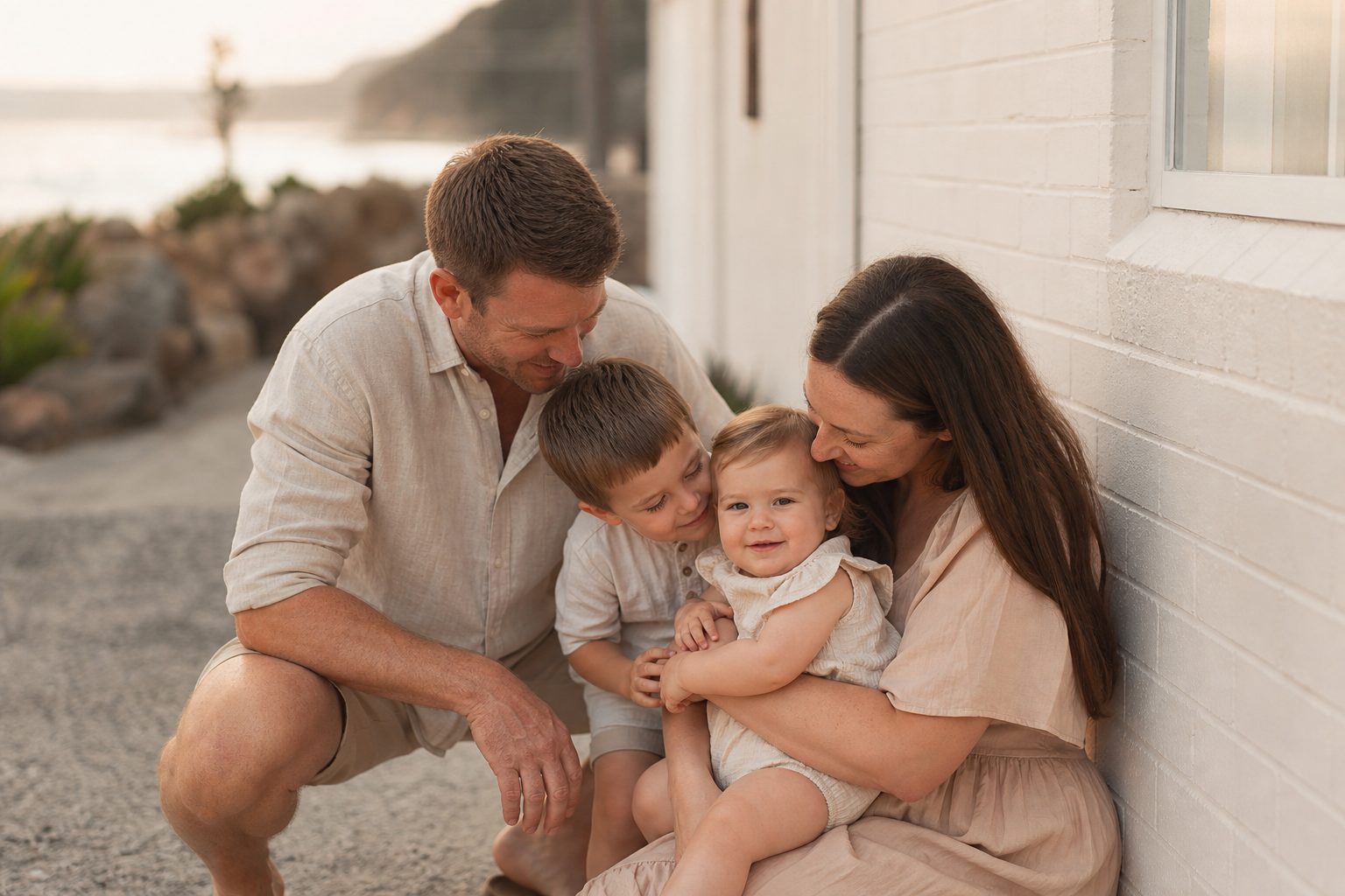 Warm portrait of a photography family outside a small coastal studio